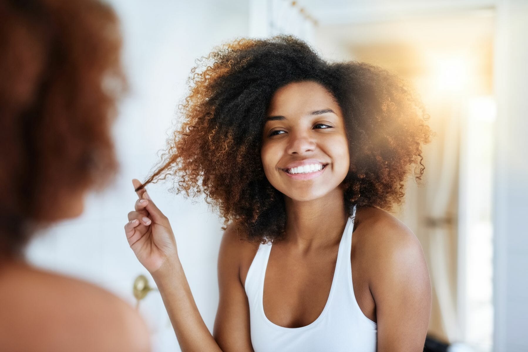Keeping it real with her hair care routine. Shot of an attractive young woman going through her morning haircare routine. Shot of an attractive young woman going through her morning haircare routine.